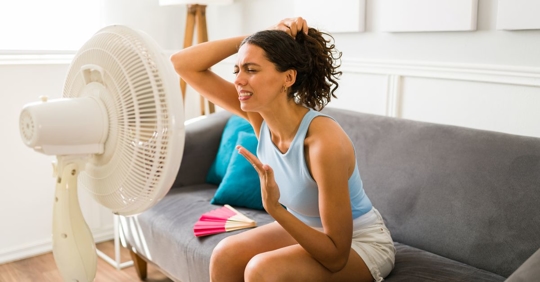 woman using fan in home