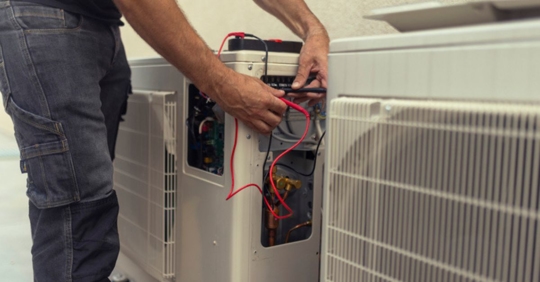 technician working on a heat pump