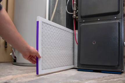 homeowner changing a furnace filter